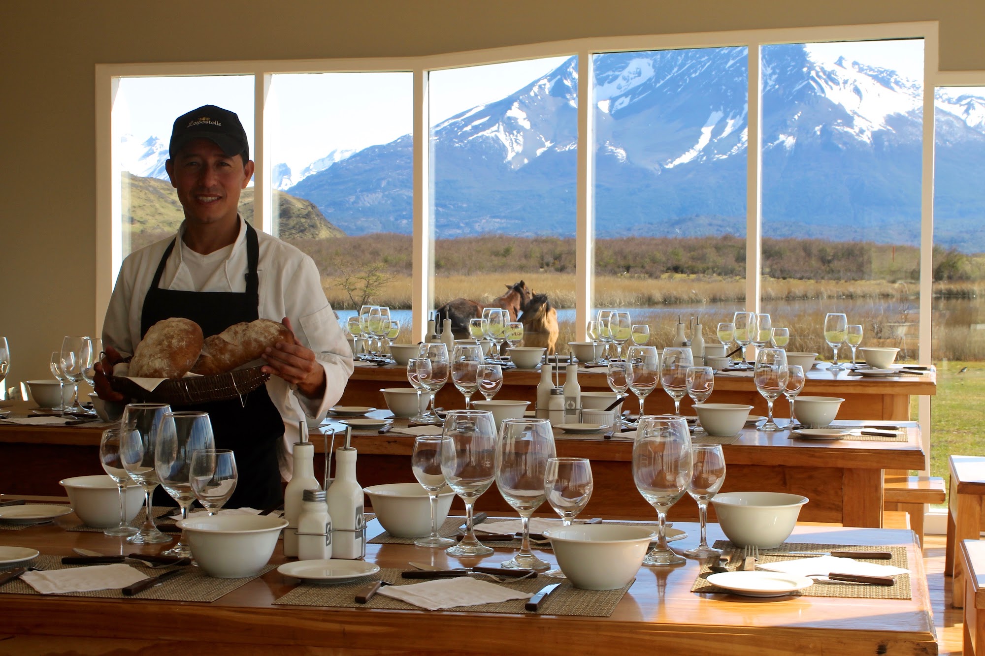 Lunch table set with lamb, salads and wine inside the house